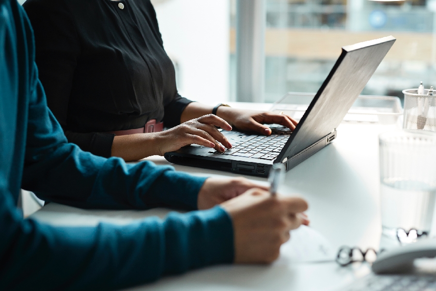 A cybersecurity advisor working on a laptop