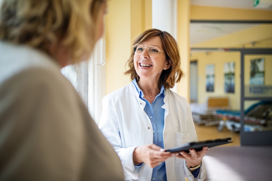 A doctor with a tablet talking with a patient