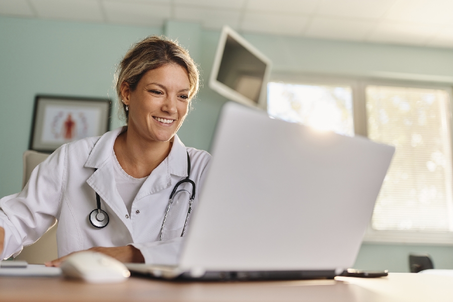 A doctor working on a computer